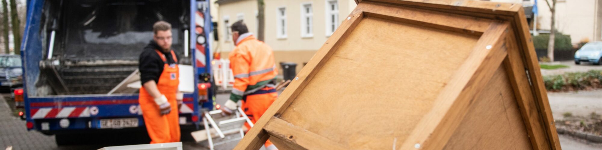 Mitarbeiter von GELSENDIENSTE laden Sperrmüll in ein Sammelfahrzeug.